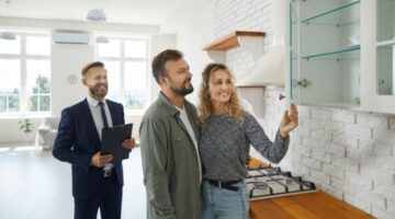 A couple viewing a property with an estate agent.