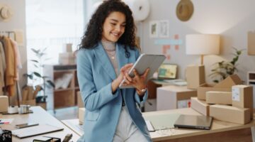 A female business owner using a tablet in an office.