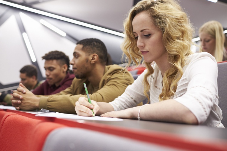 A group of students in a university lecture hall.