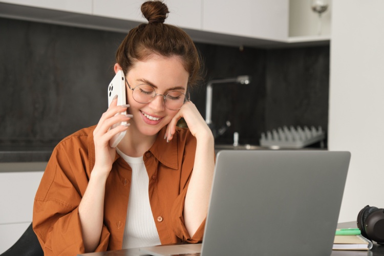 A young woman talking on the phone.